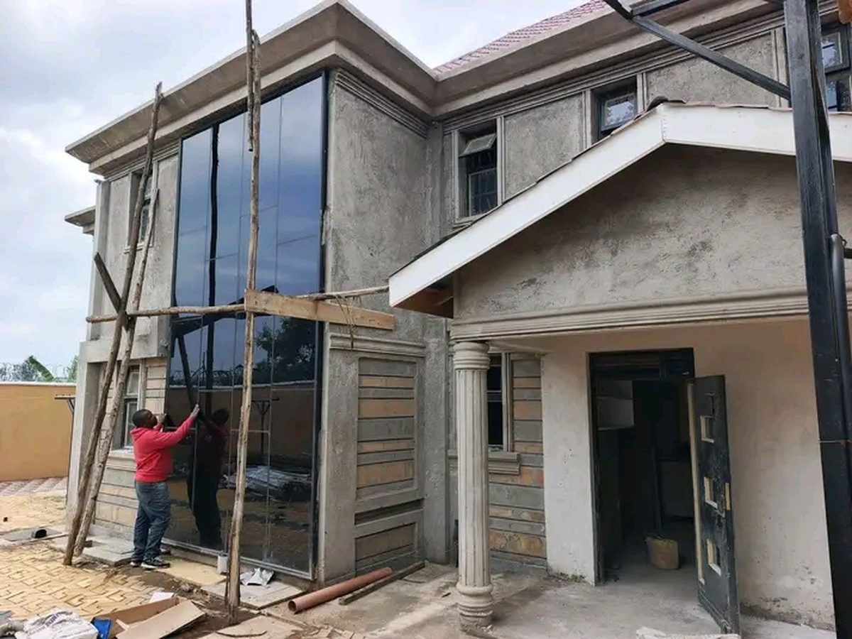 Edlan Builders and Suppliers crew installing glass on a completed home